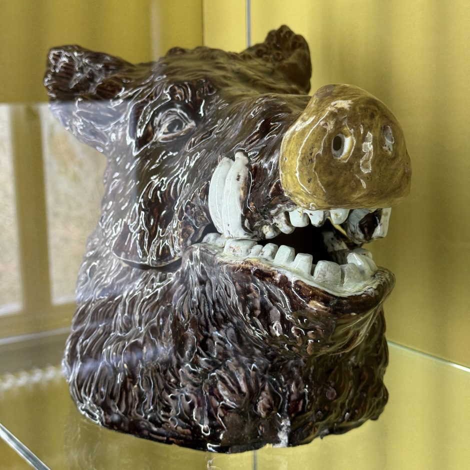 Oblique front view of a brown ceramic boar's head